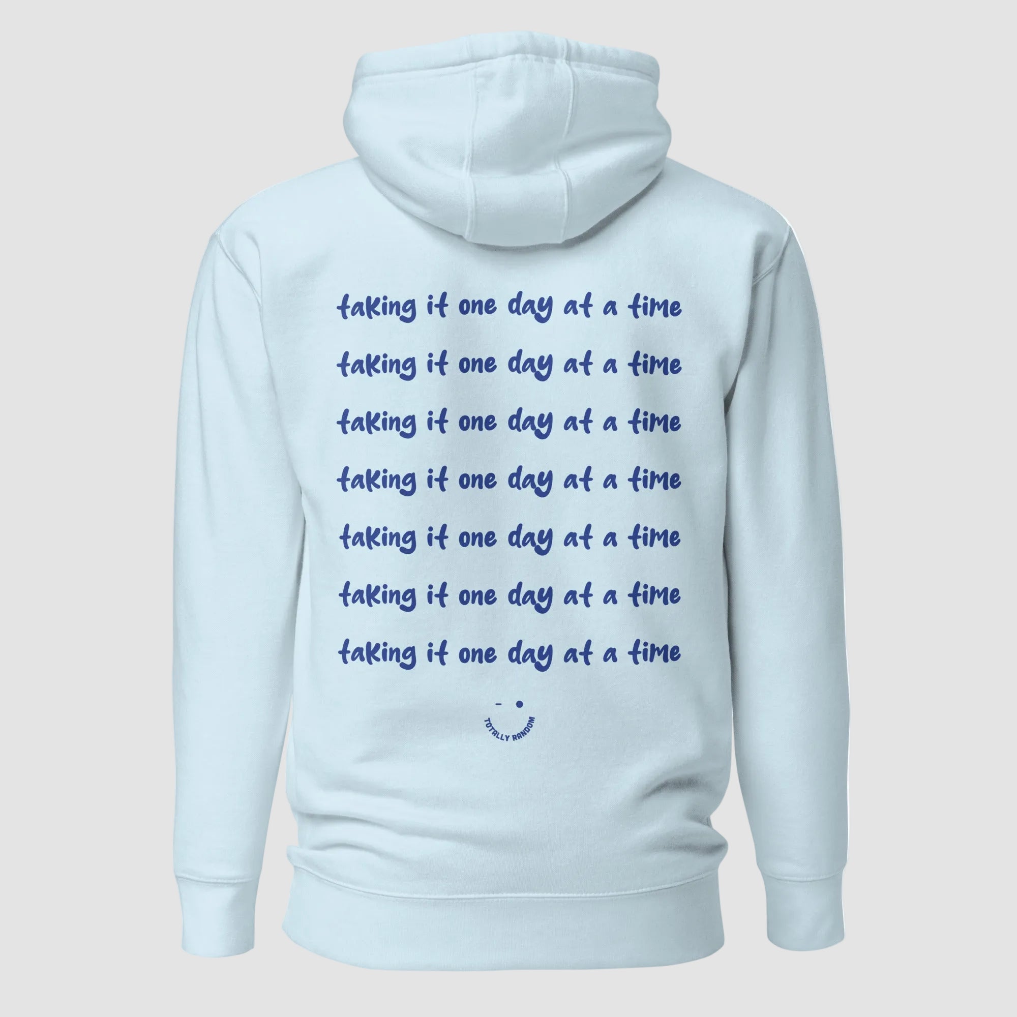 mockup retro felpa unisex azzurra con cappuccio e scritta blu in inglese sulla schiena taking it one day at a time - Totally Random®