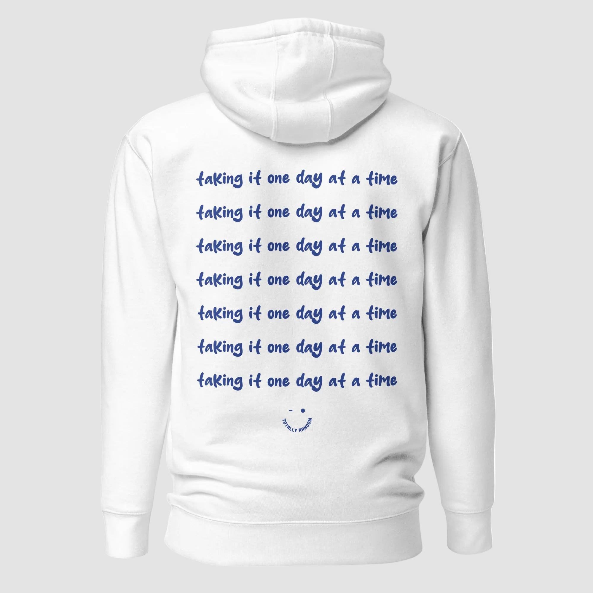 mockup retro felpa unisex bianca con cappuccio e scritta blu in inglese sulla schiena taking it one day at a time - Totally Random®